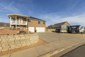 View of front of home with concrete driveway, an attached garage, and brick siding