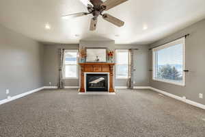 Unfurnished living room with a fireplace with flush hearth, a ceiling fan, carpet flooring, and recessed lighting