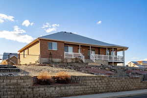 View of front of house featuring a porch and brick siding