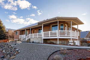 Ranch-style house featuring a porch and brick siding