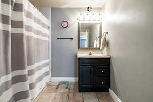 Bathroom featuring vanity, a shower with shower curtain, and light tile patterned floors