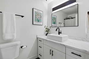 Full bath with vanity and a shower with curtain