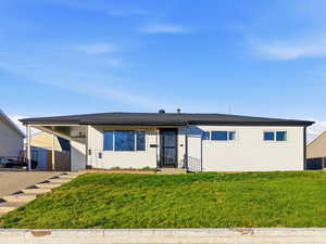 View of front of property with a front lawn and driveway