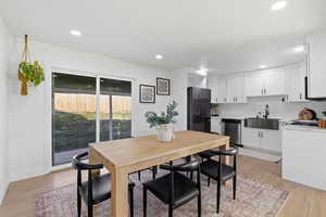 Dining room featuring light wood finished floors and recessed lighting