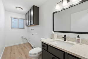 Bathroom with vanity and light wood-style floors