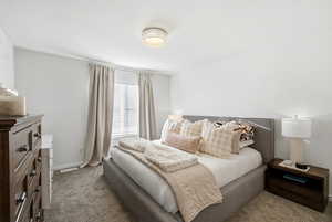 Bedroom with dark carpet and baseboards