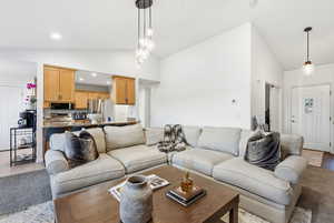 Living room featuring high vaulted ceiling