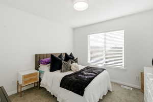 Carpeted bedroom featuring baseboards