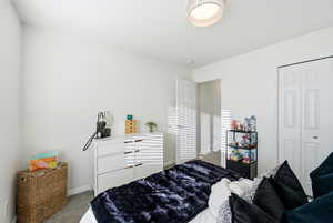 Bedroom with carpet and a closet