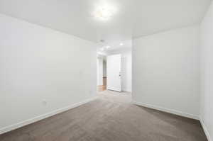 Carpeted empty room with recessed lighting and a textured ceiling