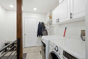 Washroom featuring cabinet space, independent washer and dryer, and recessed lighting