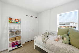 Bedroom with carpet flooring and a closet