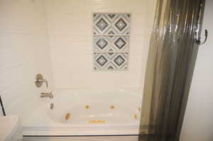 Full bathroom featuring a combined bath / shower with jetted tub