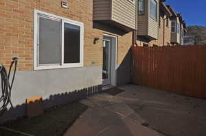 Property entrance with a patio area and brick siding