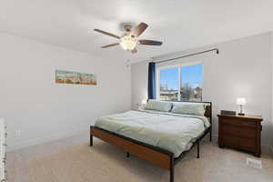 Bedroom with light carpet and ceiling fan