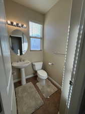 Bathroom featuring tile patterned floors and toilet