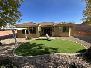 Rear view of house with stucco siding, a patio, a fenced backyard, and a tile roof