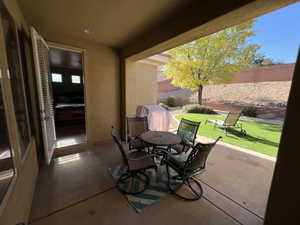 Fenced backyard featuring a patio and a grill