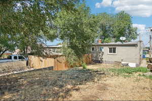 Rear view of house featuring brick siding and a chimney