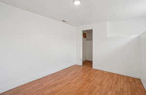 Spare room with light wood-style flooring and a textured ceiling