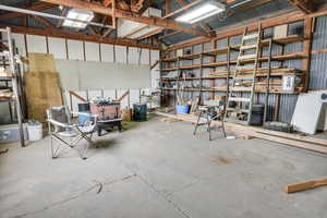 Garage with metal wall and white fridge