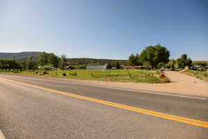 View of asphalt street featuring a mountain view