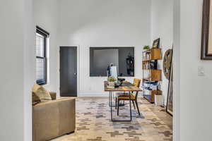 Office with a high ceiling and baseboards