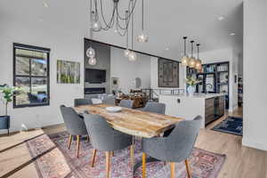 Dining space featuring recessed lighting, light wood finished floors, and a large fireplace
