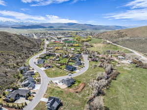 Aerial overview of property's location featuring a mountain backdrop and nearby suburban area