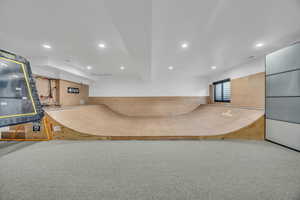 Interior space with light carpet and recessed lighting