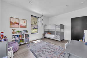 Bedroom featuring light wood-style floors, recessed lighting, and a desk