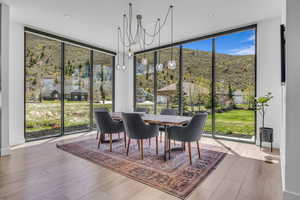 Sunroom with a chandelier and a mountain view