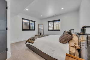 Bedroom with light carpet and recessed lighting