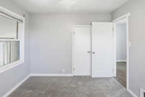 Bedroom featuring carpet flooring and baseboards