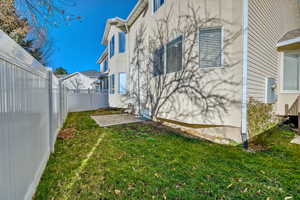 View of side of home with a fenced backyard, a patio area, and stucco siding
