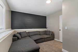 Carpeted living room with baseboards