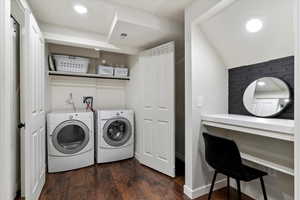 Washroom featuring dark wood-style flooring, washing machine and dryer, and recessed lighting
