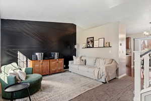 Living area featuring carpet floors and a chandelier