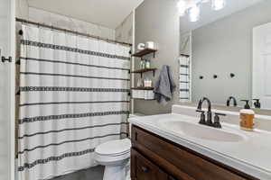 Full bath with vanity and a shower with shower curtain