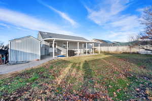 Back of house with roof with shingles and a patio area