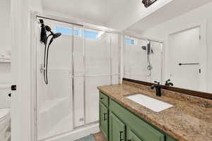 Bathroom featuring a stall shower and vanity
