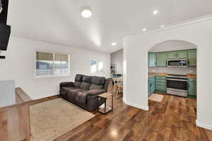 Living area featuring recessed lighting and dark wood-style floors