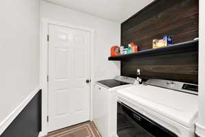 Laundry room with washing machine and clothes dryer