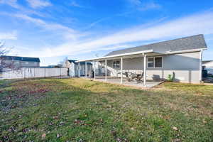Back of property featuring a patio area, a shingled roof, and ceiling fan