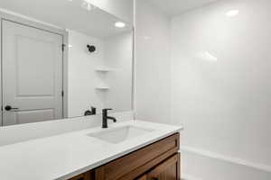 Bathroom featuring vanity, recessed lighting, and shower / tub combination