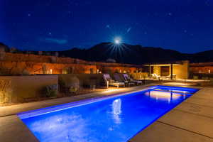 Pool at twilight with a patio area