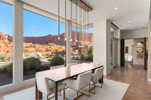 Dining room featuring a mountain view, recessed lighting, floor to ceiling windows, and finished concrete floors