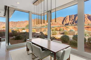 Sunroom / solarium with a mountain view, expansive windows, recessed lighting, and concrete floors