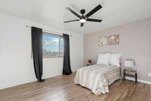Bedroom with light wood-style flooring and ceiling fan
