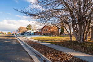 View of front of home featuring a residential view, a garage, and brick siding
